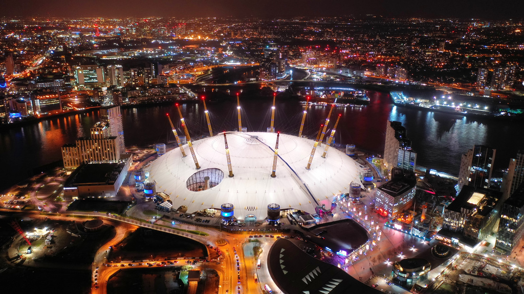 An aerial view of the iconic O2 Arena at night, highlighting its vibrant surroundings as a prime location for the Arenas Operators & Developers World Summit 2026.