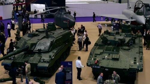 Military technology showcase with tanks, helicopters, and jets