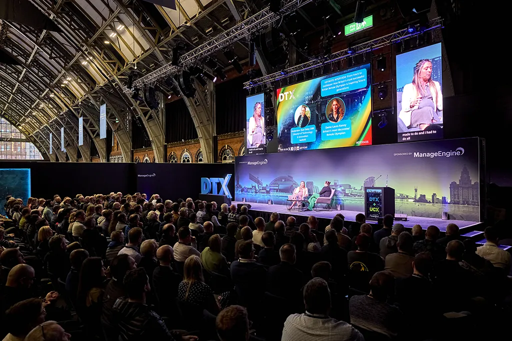 Crowd at event with large screens