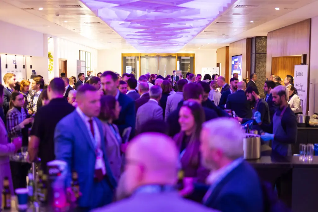A bustling networking session at Financial Crime 360, bringing together industry leaders to combat financial crimes.