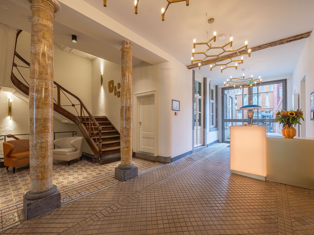 a hallway with columns and a staircase