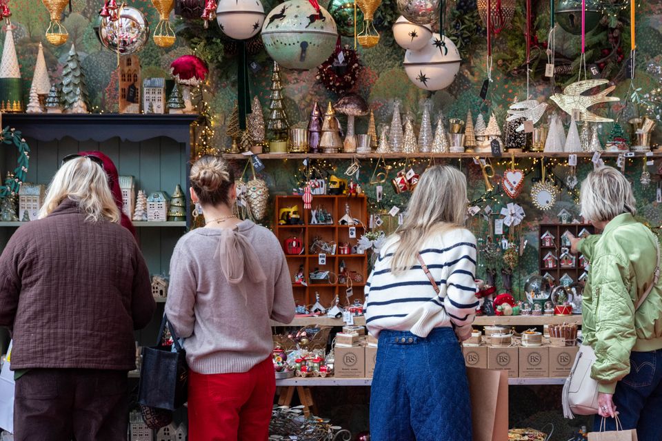 A group of people browsing a festive display.
