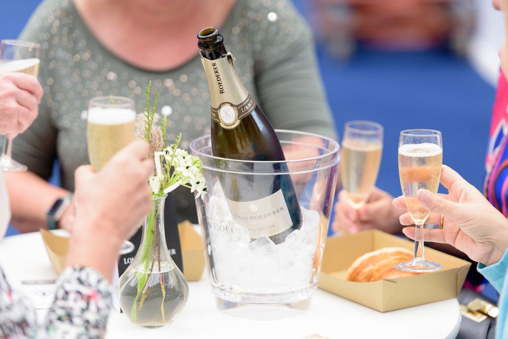 A group of people holding glasses of champagne.